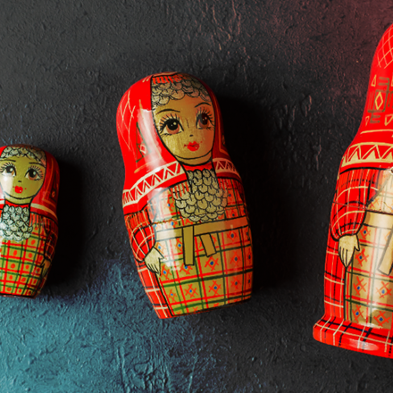 Russian style Matryoshka dolls that laying side by side on a surface.