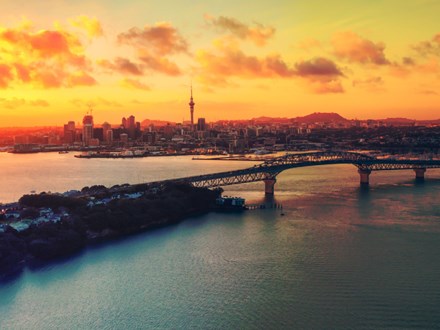 Auckland Harbour bridge and skyline at sunset