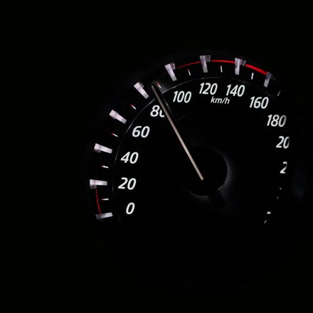 Dark image of a speedometer