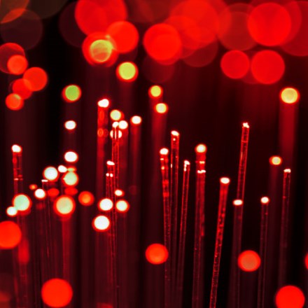 Red fibre optics abstract background. Shallow depth of field. Beautiful bokeh, space for copy.