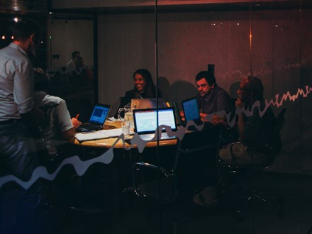 A group of people starting a business, working late into the night. 