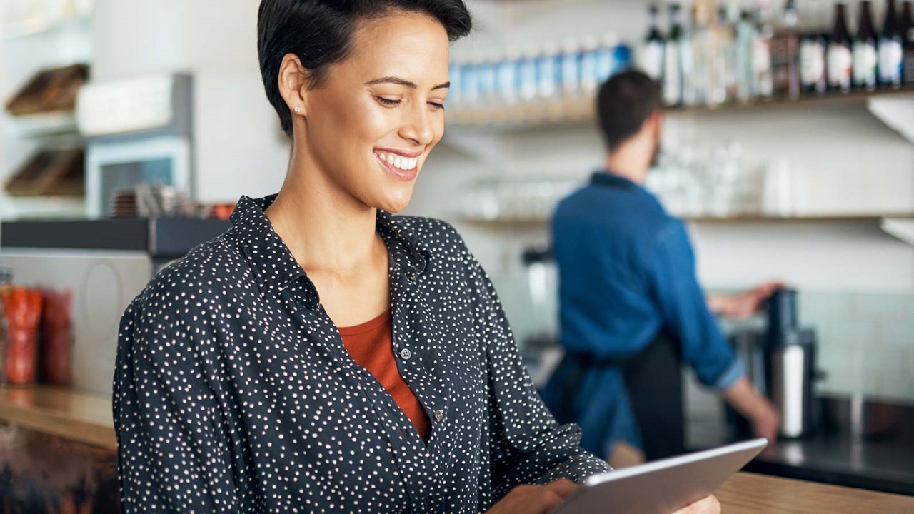 Woman looking at tablet in small business