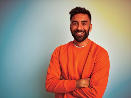 Indian man in orange jumper