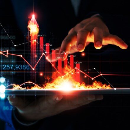 Business growth. Businessman holding tablet and a hot of fire glowing upright arrow with analysing data and economic growth graph. Strategy. 